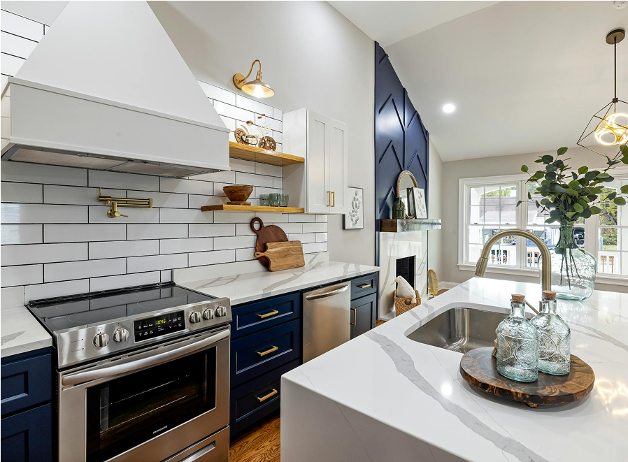 Premium Stones modern kitchen with white marble countertops and navy blue cabinetry.