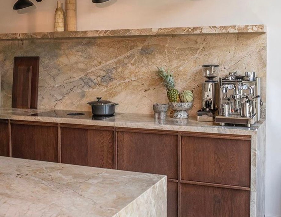 Premium Stones elegant kitchen with natural stone countertops and backsplash.