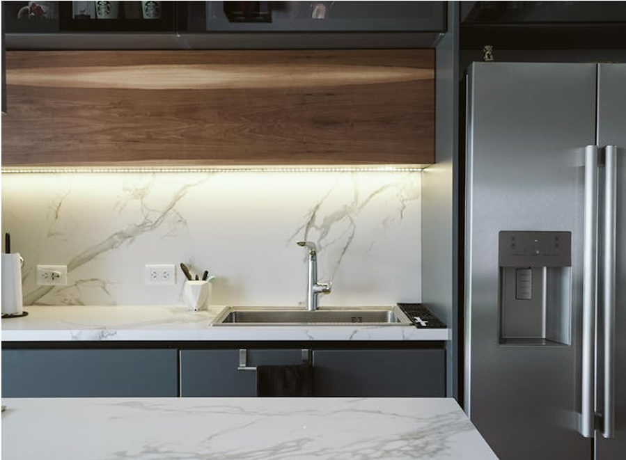 Premium Stones contemporary kitchen with white marble countertops and backsplash.
