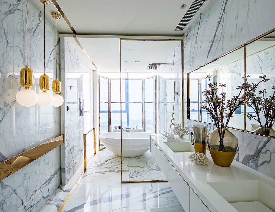 Premium Stones luxurious marble bathroom with gold accents and a freestanding bathtub.