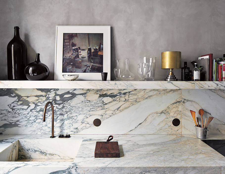 Premium Stones luxurious marble kitchen with integrated sink and modern decor.